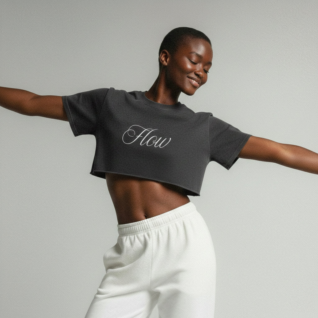 Medium studio shot of a model showcasing the vintage snow-washed texture and raw edge hem of the 7722 black Flow crop top.