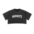 100% cotton snow-washed black crop top with a raw edge hem and arched "NAMASTE" white lettering.