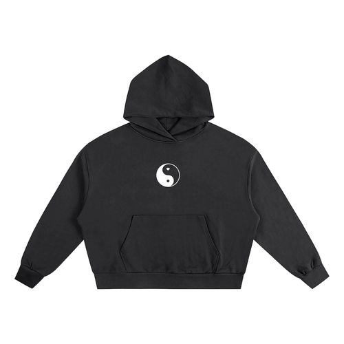 Oversized black streetwear hoodie featuring a centered white Yin Yang symbol with a small heart detail on heavyweight cotton.