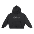Premium black boxy-fit hoodie with a minimalist white "Flow" script graphic on 100% heavyweight cotton.
