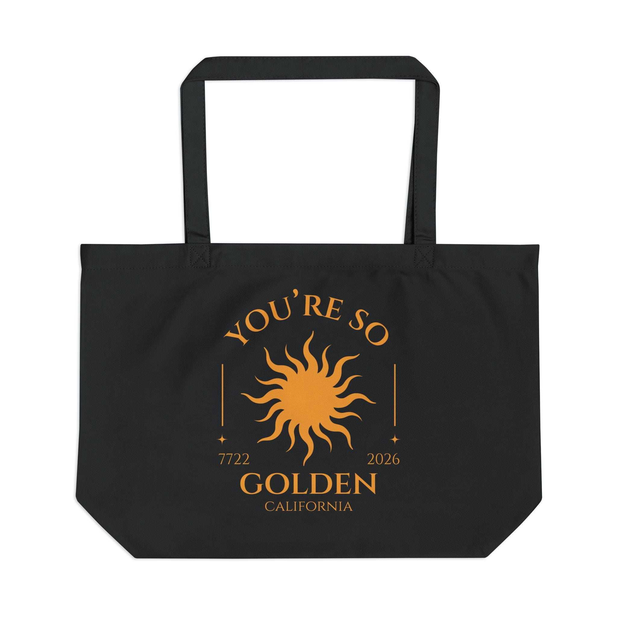 Black tote bag with gold sun design and text on a white background